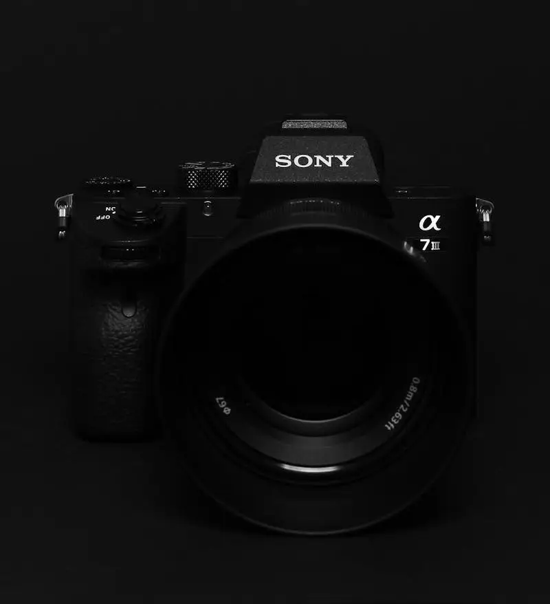 Minimalist image of a black Sony camera against a black background, perfect for tech themes.